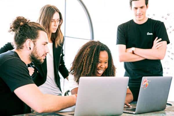 Employees engaged looking at computer together